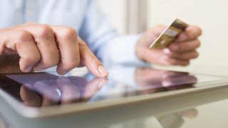 Man using tablet pc and credit card indoor, Shopping online