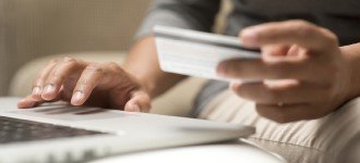ThinkstockPhotos-509722211-160x900 Close up of hands shopping online